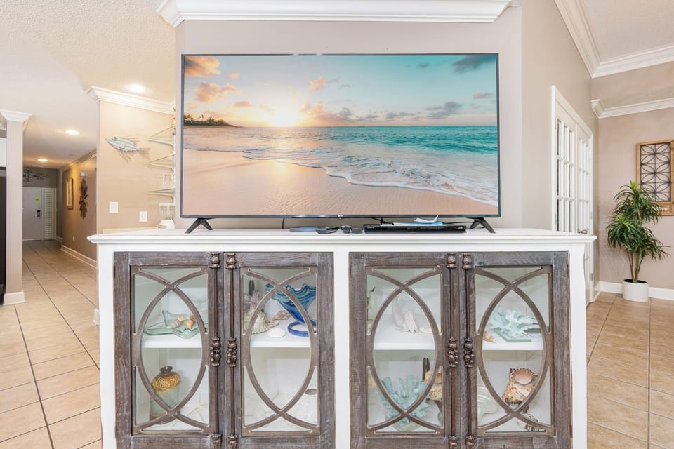 Relax in front of the large TV, enjoying movie nights with loved ones while surrounded by coastal decor
