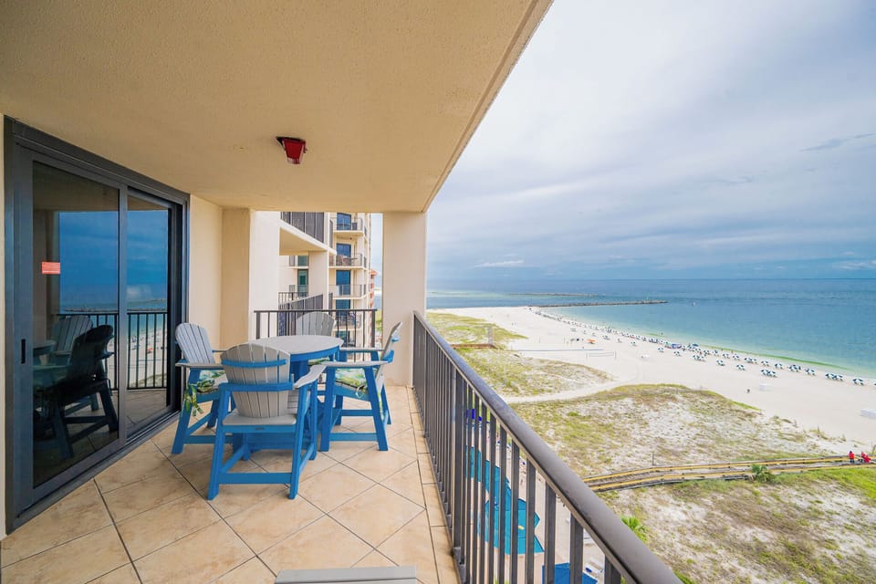 Relax on the balcony enjoying views of the beach and gentle waves in the distance