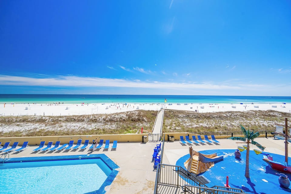The warmth of the sun guides you from the pool area through dunes to the calm, turquoise gulf shore