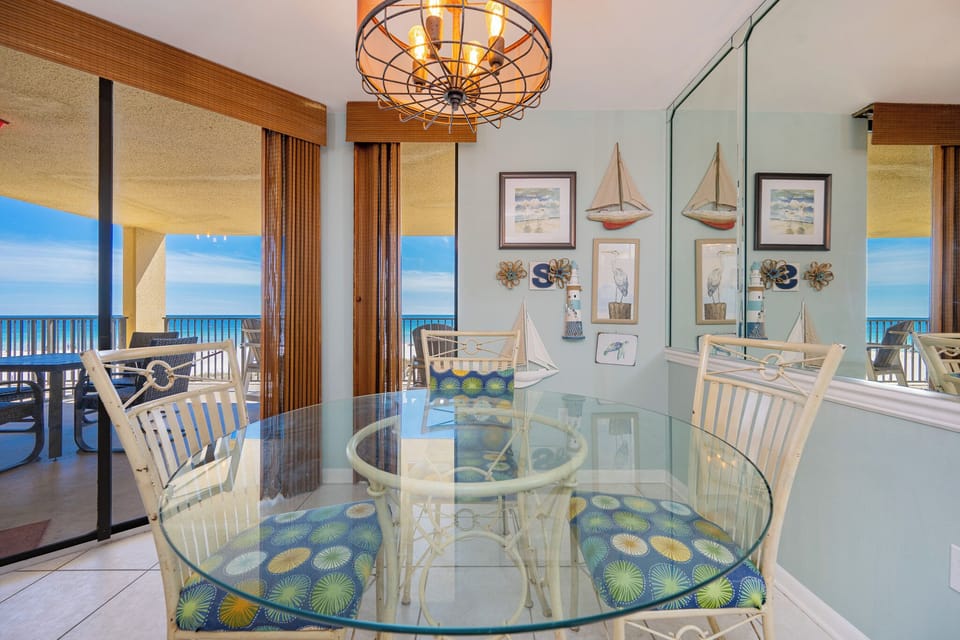 Imagine sharing meals and stories around the glass table while gazing toward your gulf coast balcony view