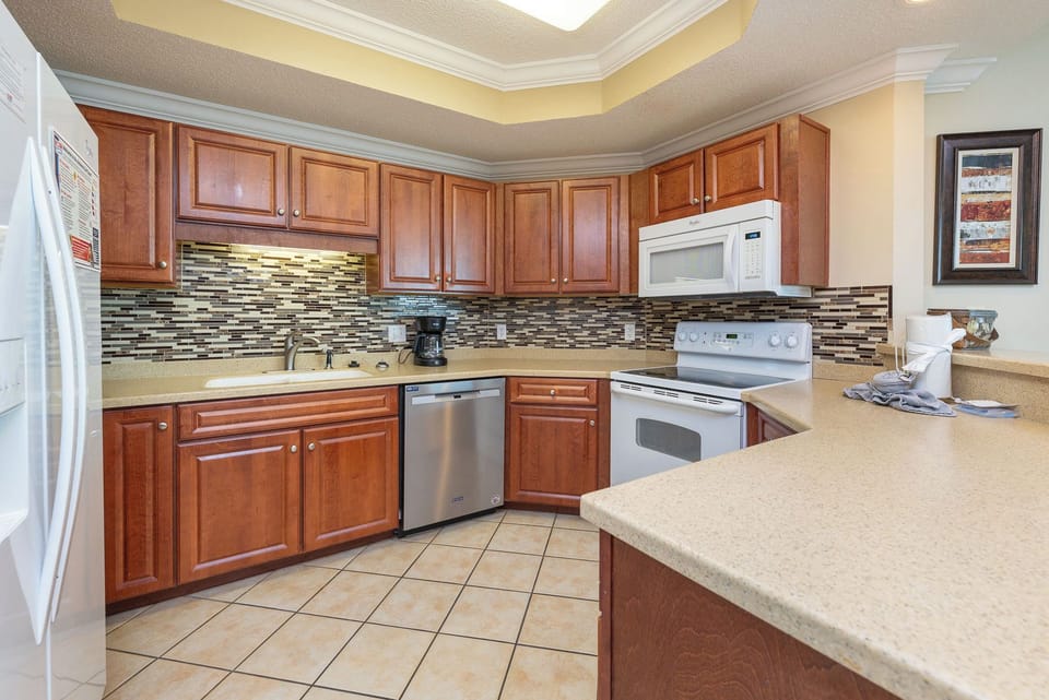 Prepare family favorites in your kitchen, enjoying the charm of rich wood cabinets and stylish backsplash