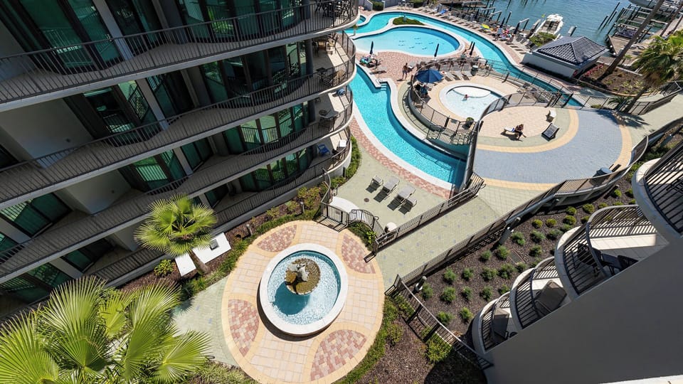 Bask in the stunning views of the pool and marina as you unwind on your balcony, embracing the coastal vibe