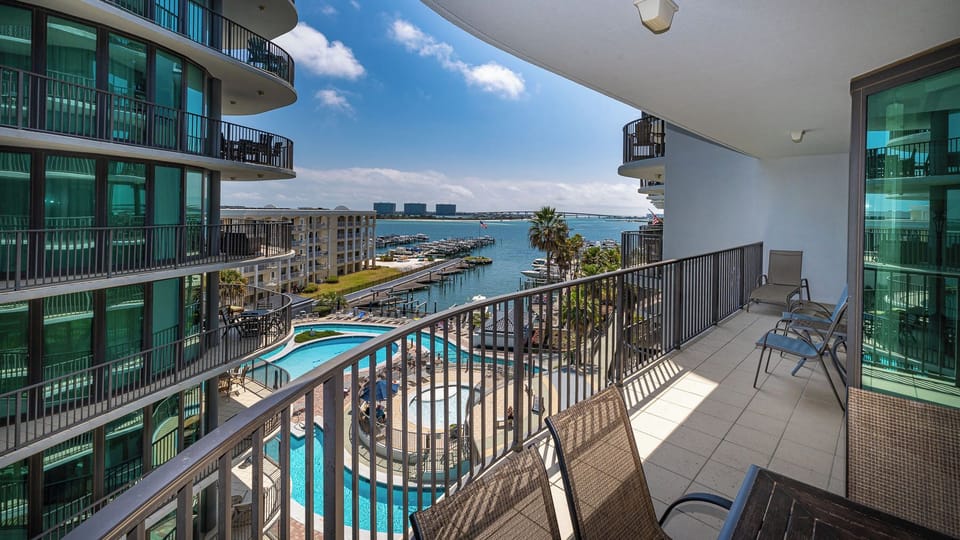 Relax in comfortable chairs on your balcony as you gaze out at stunning views of the sparkling marina and pool