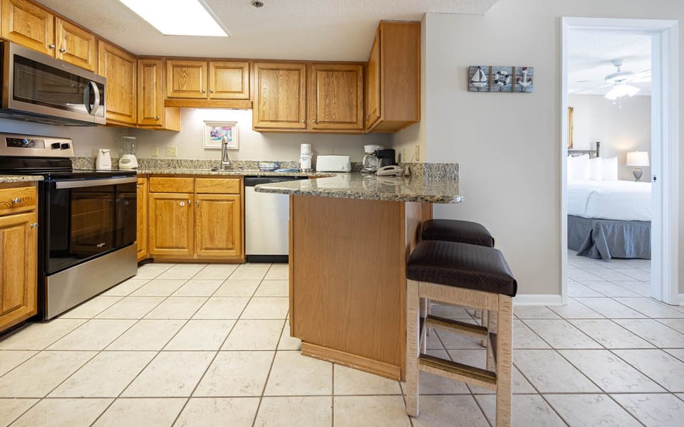 Cook and gather in this kitchen, featuring wooden cabinets and a breakfast bar