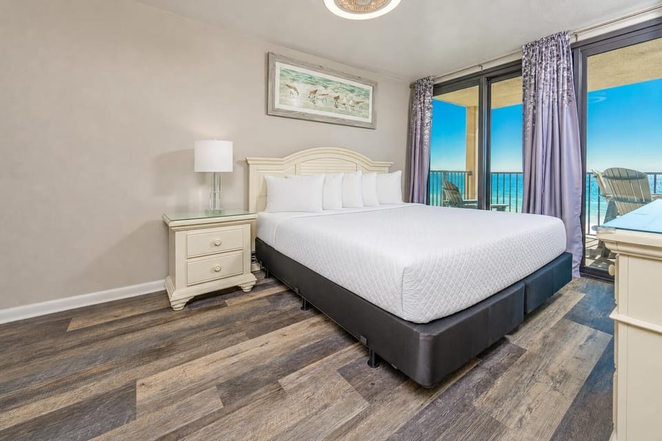Unwind in this inviting master suite, where plush king bedding and stunning views await after a day at the beach