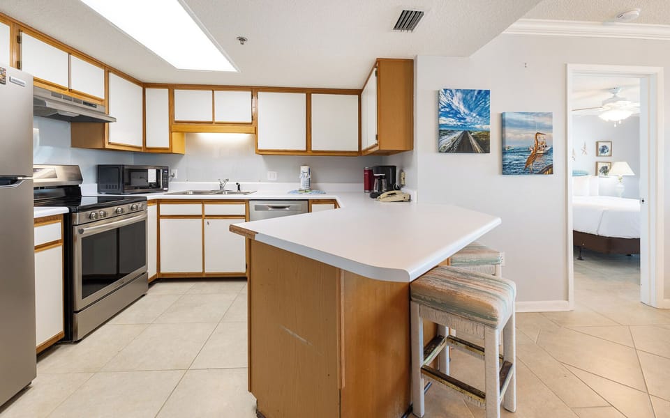 Gather around the inviting bar stools, sharing laughter and stories while enjoying easy access to the well-lit kitchen space