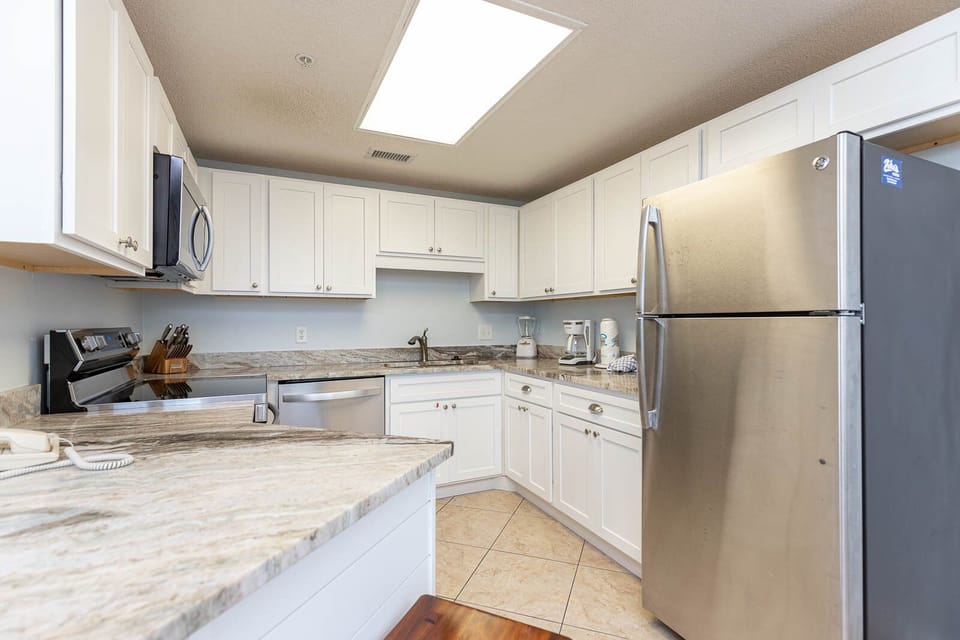 Cook with ease in the functional kitchen featuring sleek appliances and ample counter space for meal preparation