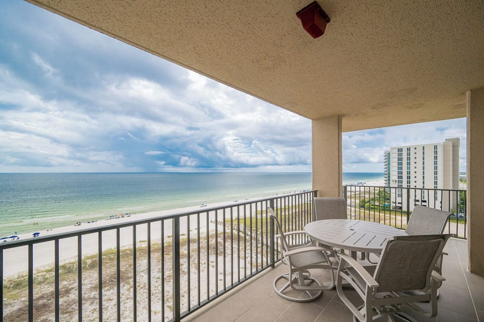 Relax at the outdoor dining table while enjoying views of the tranquil waters and beach below