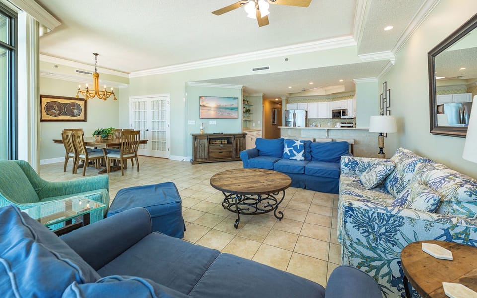 Soft cushions and coastal decor surround you in this spacious living room perfect for relaxing and reconnecting