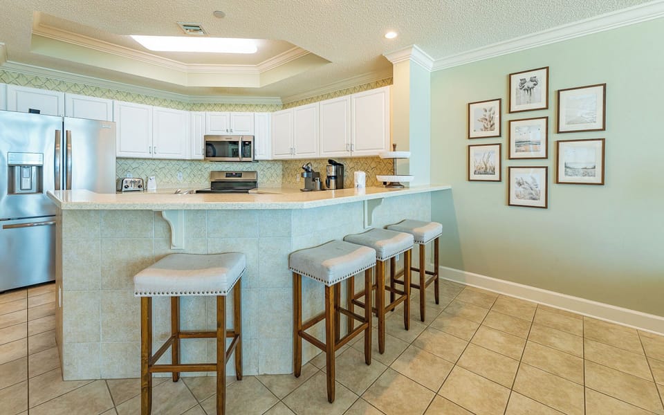 Gather around the breakfast bar to sip coffee and share stories in this inviting kitchen