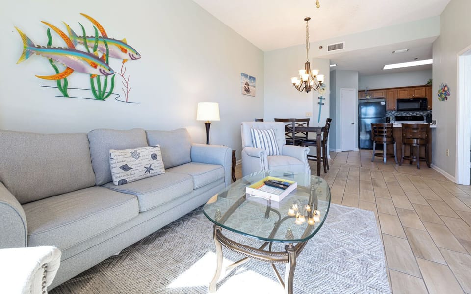 Unwind on the comfortable sofa with queen sleeper, surrounded by beach decor and beachfront views