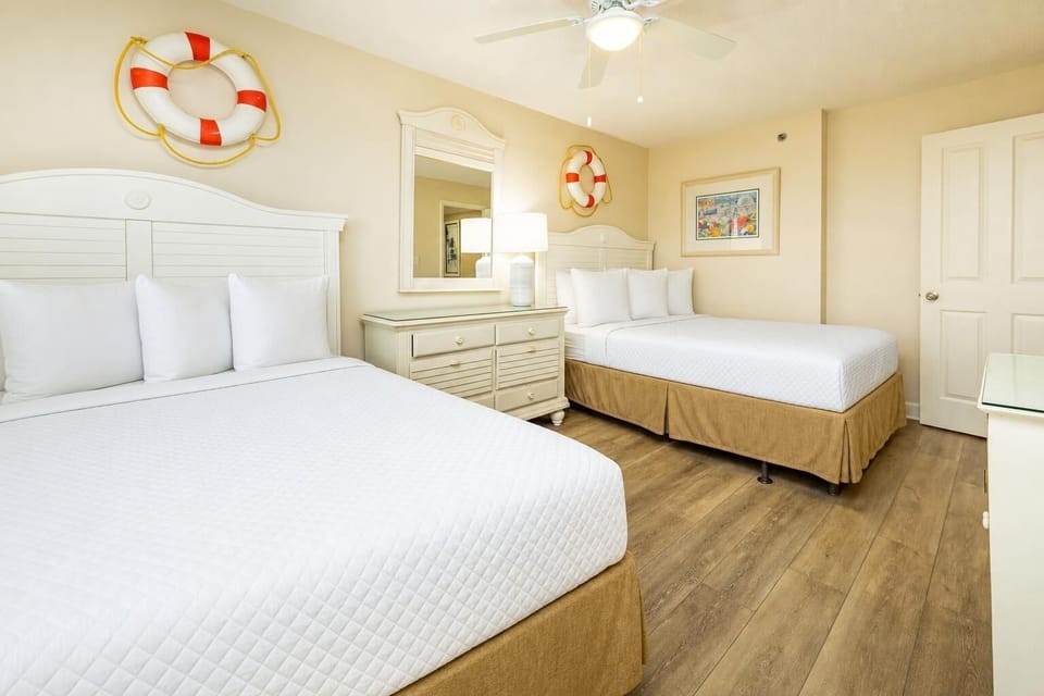 Guest suite with two queen beds invites restful sleep after a day of coastal adventures and family fun