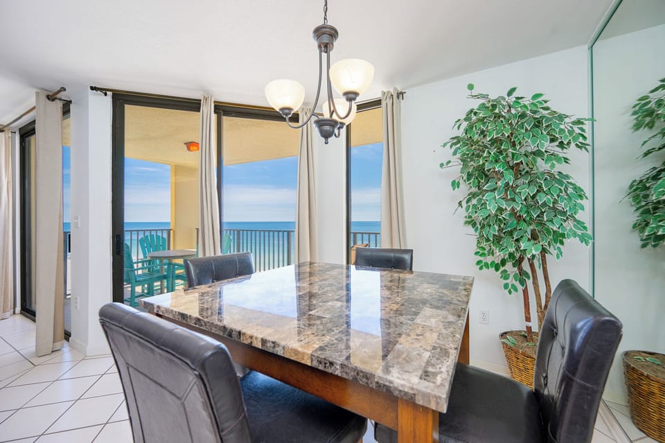 Imagine sharing meals around the cool stone table as you catch beach views through bright glass doors in the living room
