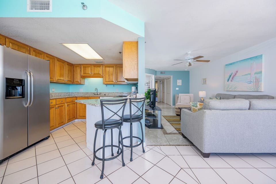 Sit at the breakfast bar while the kitchen's glow invites you to prepare fresh gulf coast meals in the living room