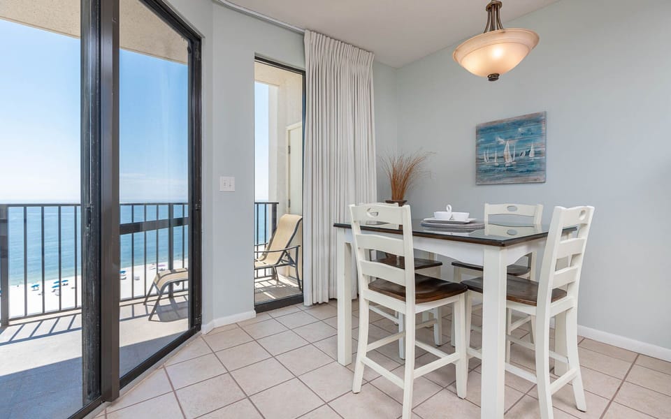 Enjoy meals at the dining table with a beach view, complemented by coastal decor and natural light streaming in