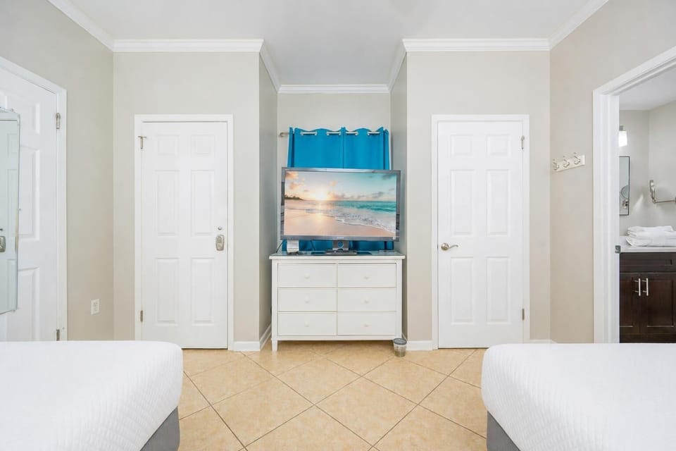 Enjoy cozy movie nights on the double beds while making lasting memories with family in this guest bedroom