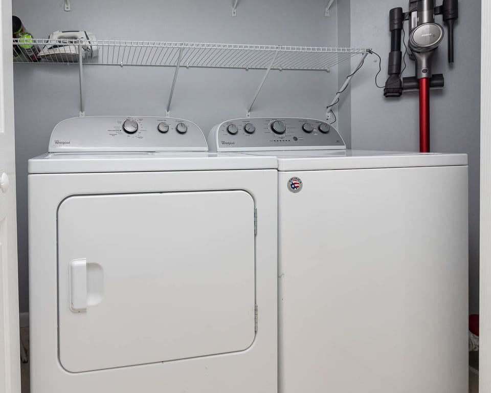 Conveniently handle laundry with a washer and dryer, complemented by storage space for your essentials
