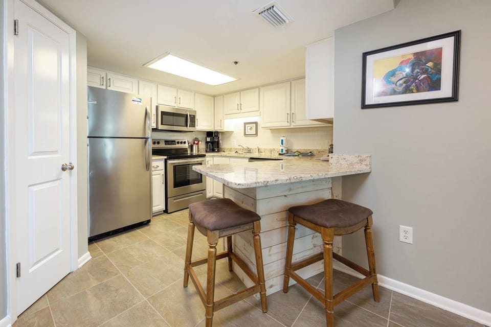 Enjoy cooking in this inviting kitchen with stainless appliances, granite countertops, and a breakfast bar