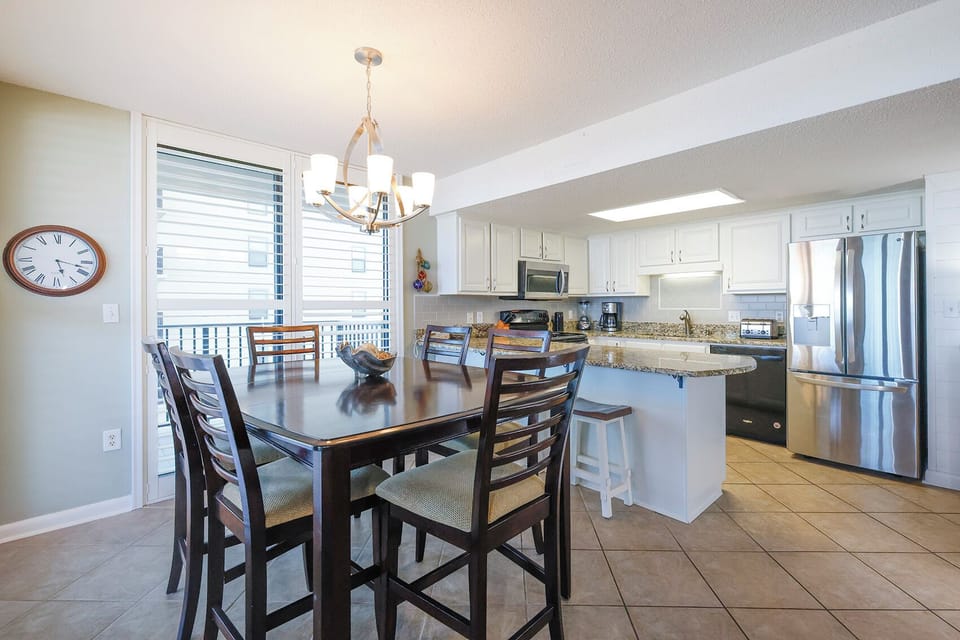 Gather around the dining table for meals with a beachfront view