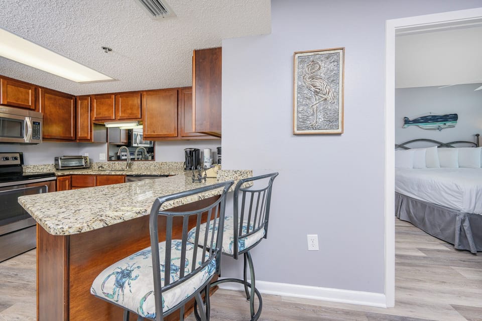 Gather at the breakfast bar enjoying a view of the inviting kitchen with coffee and conversation