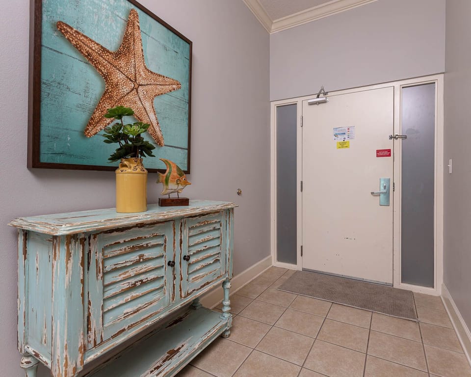Step into a vibrant entryway adorned with beach-inspired decor, setting a cheerful tone for your getaway