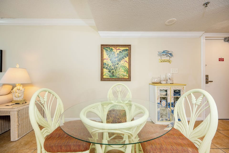 Gather around the glass table, enjoying family games under the warm glow of the charming lamp nearby