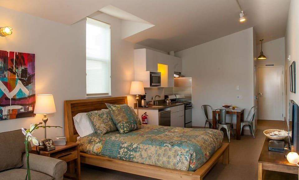 Reclaimed teak queen bed with handmade quilt in aqua tones.