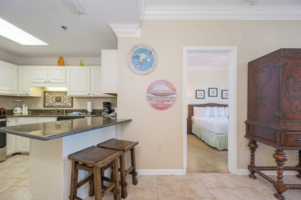Prepare meals in this inviting kitchen, featuring stainless appliances and a cozy breakfast bar