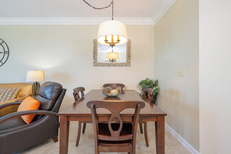 Gather around the wooden dining table set with vibrant placemats, perfect for meals and conversation with loved ones