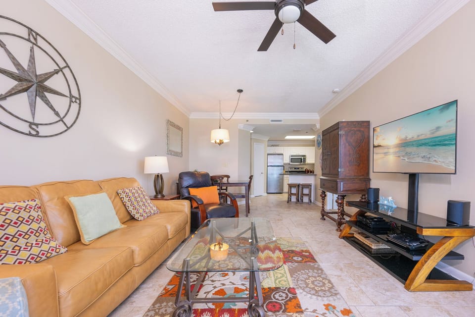 Relax in the inviting living area, featuring comfortable seating and a vibrant area rug for a cozy vibe
