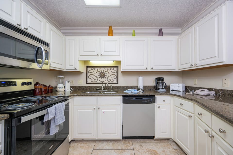 Prepare your favorite meals in this bright kitchen, featuring stainless appliances and ample counter space