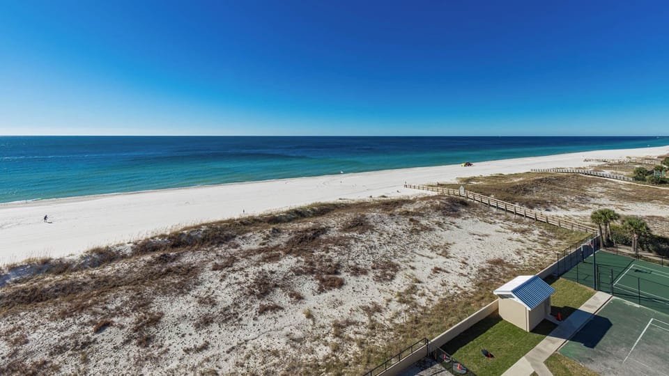 Gaze at the tranquil waters and soft shoreline, perfect for relaxing vacation moments and creating lasting memories