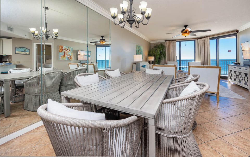 Dine at the spacious table surrounded by comfortable chairs, with beautiful beach views and a cozy atmosphere