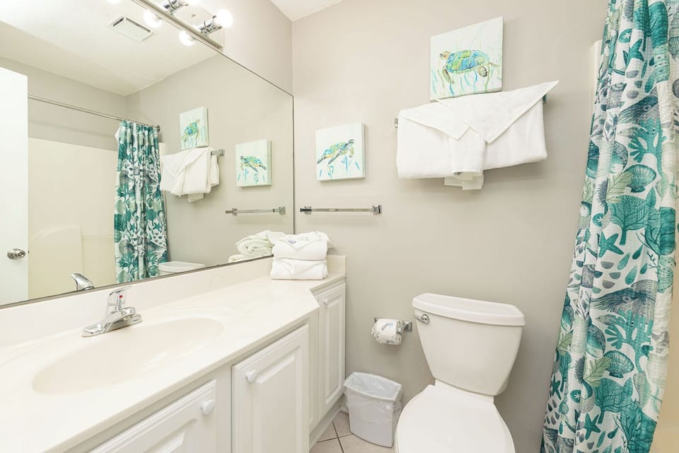 Refresh and rejuvenate in the guest bathroom, enjoying the serene vibe with lovely decor and plush towels