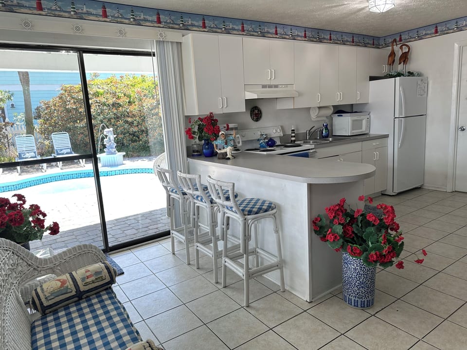 Kitchen with sliding door to  pool area