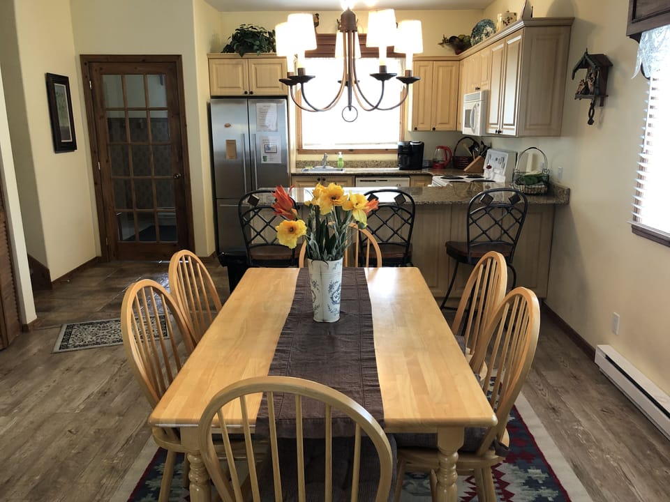 Dining Area looking to kitchen -breakfast bar and vestibule