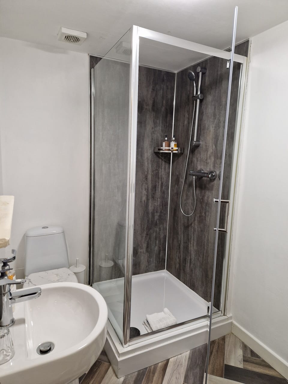 Shower, designer toiletries, hair dryer, towels