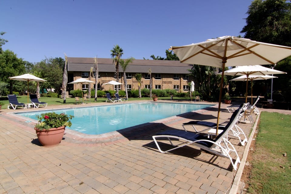 Outdoor pool, pool umbrellas, sun loungers