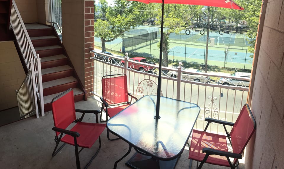 Front deck complete with table, chairs, and umbrella for your enjoyment.