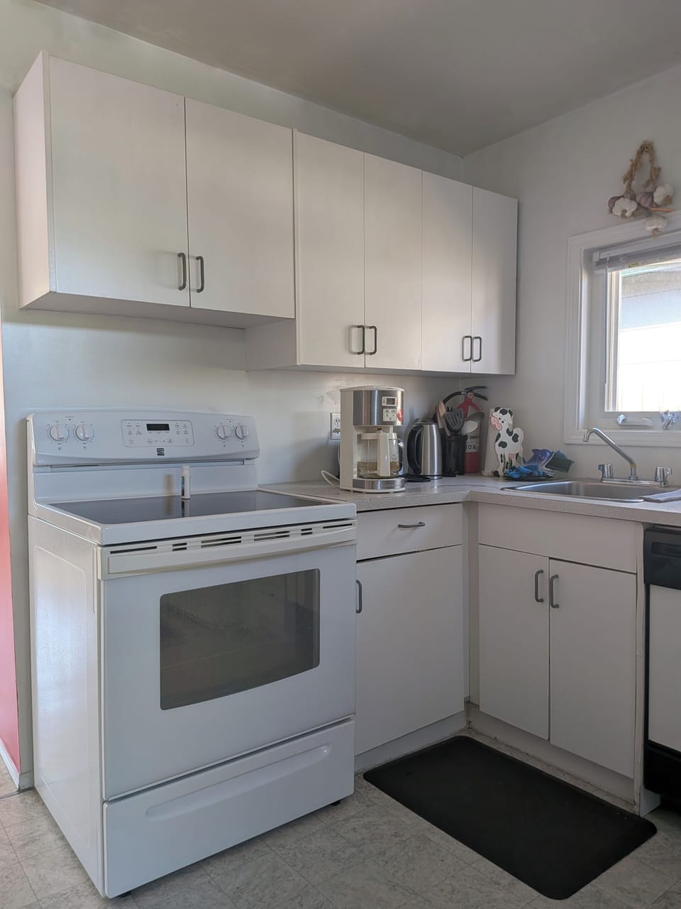 kitchen visible coffee maker, , oven, stovetop 
 left of a great fridge  2026