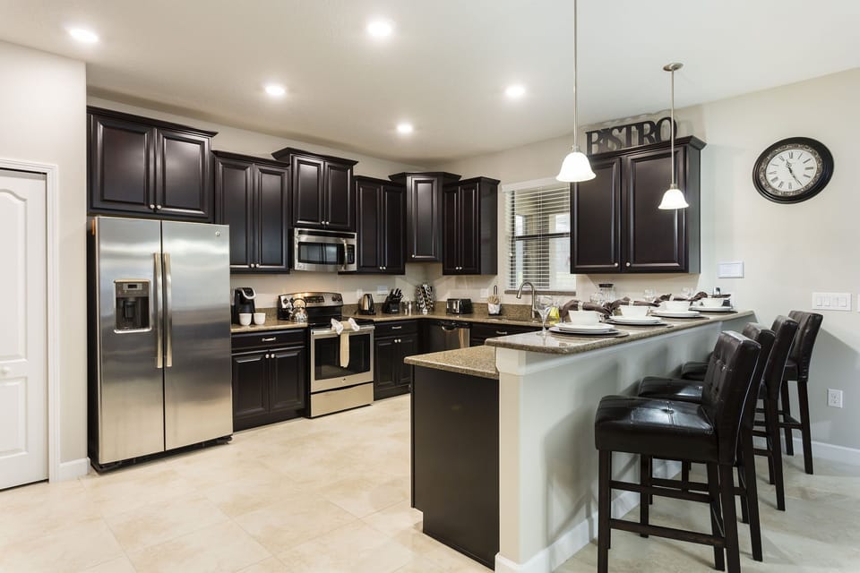 The fully-equipped kitchen has stainless steel appliances, granite counters and breakfast bar seating for 4