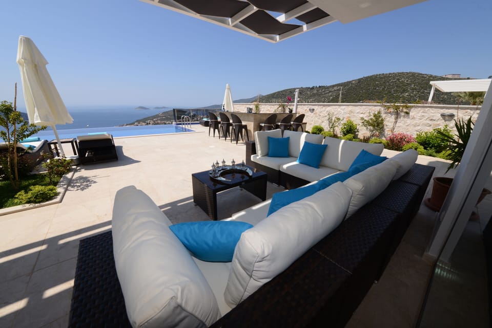 Shaded seating area with spectacular views over the pool, the bay & the islands