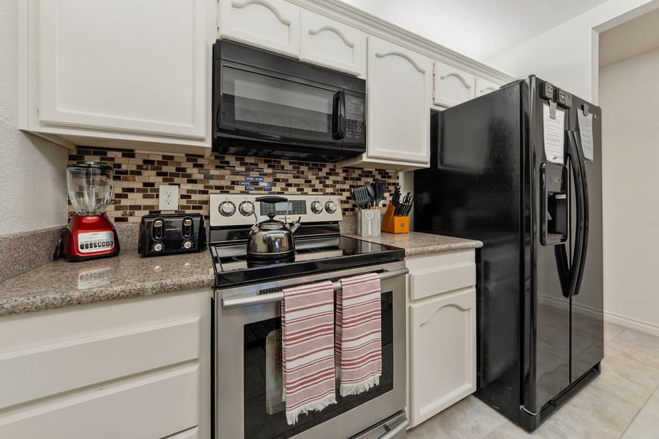 Fully stocked kitchen with Air Fryer, Blender. Coffee Bar is in the dining room!