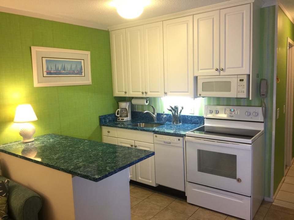 Kitchen with new quartz countertops, new sink/faucet, and new range.