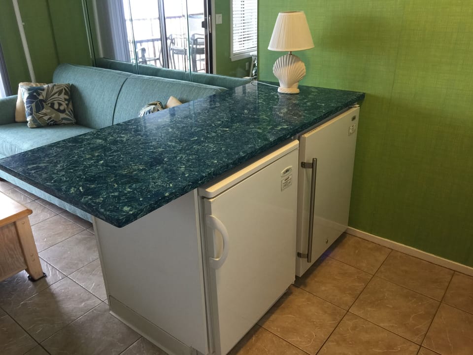 Gorgeous new quartz counter tops in the kitchen area. Refrigerator and Freezer.
