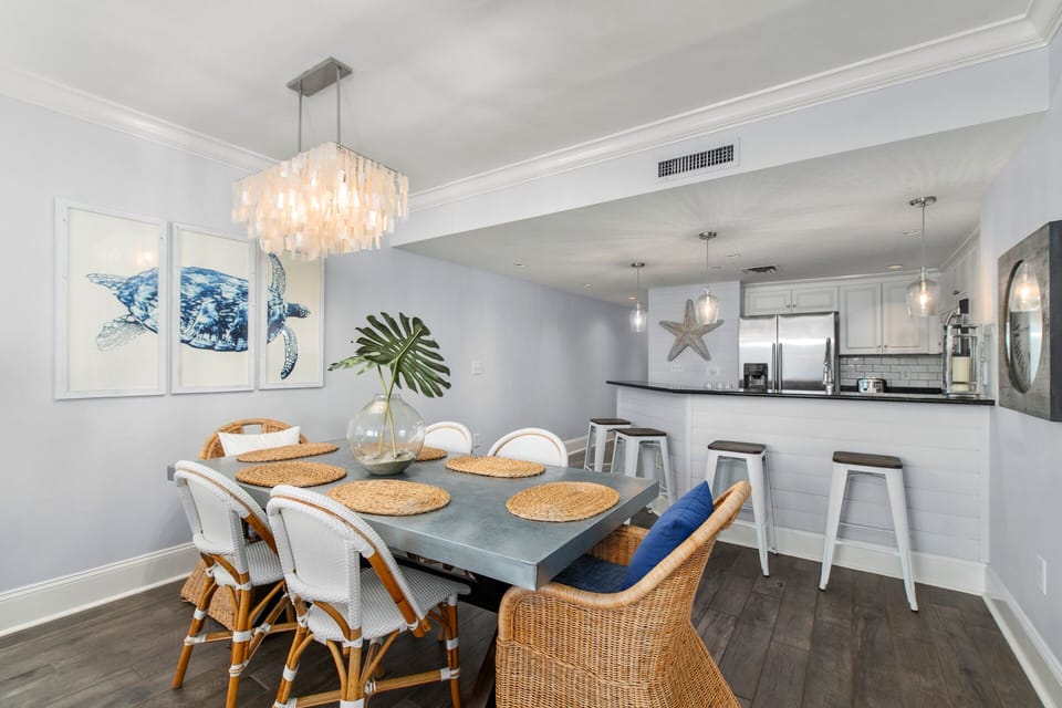 Dining area with seating for six and adjacent kitchen bar seating

