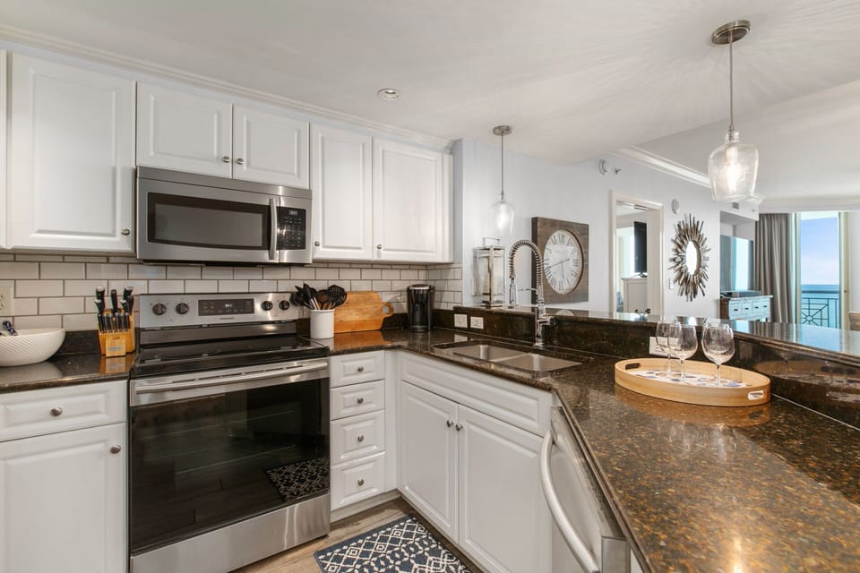 Updated kitchen with granite countertops and stainless steel appliances
