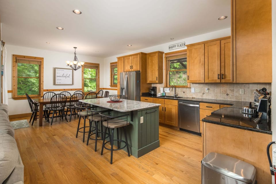Updated kitchen with granite countertops, stainless steel appliances, and a dining area for gathering together