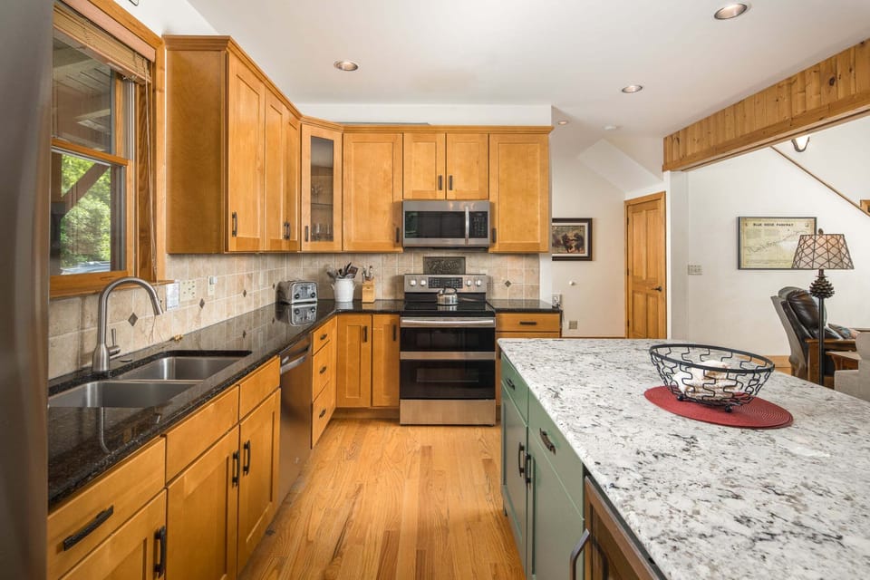 Spacious kitchen with custom cabinetry, granite countertops, and stainless steel appliances