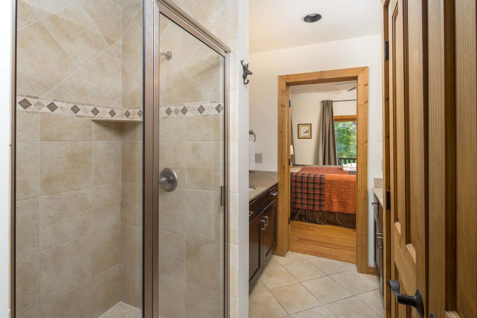 Private ensuite bathroom with a tiled walk-in shower and separate soaking tub